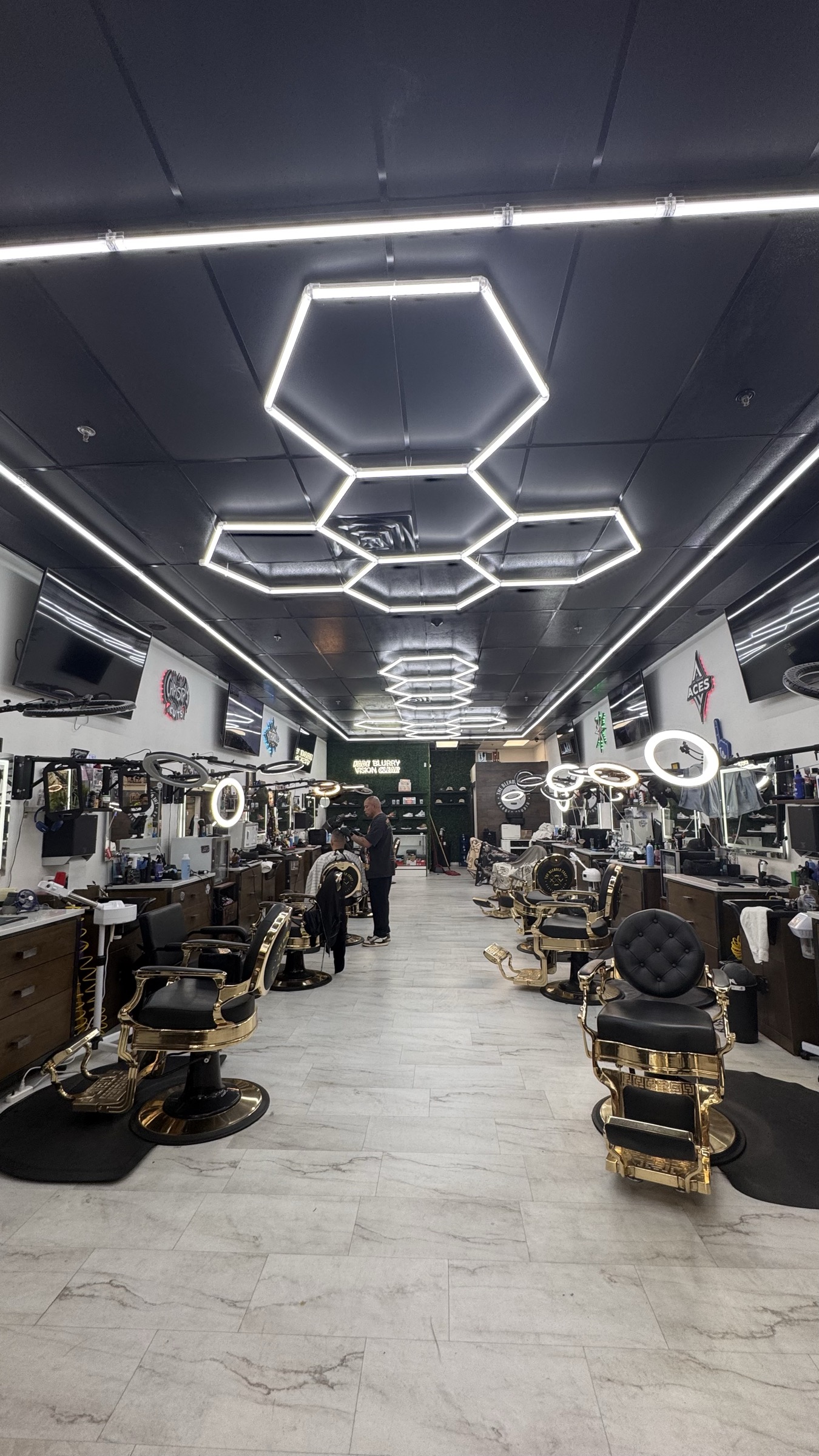 Hexagonal LED lights and premium barber chairs inside Blended Craft